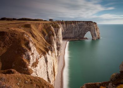 The Manneporte arch, pebbled beach and coastline of Etr ... 