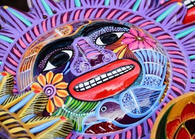 Photograph of a colorful ceramic sun handicraft