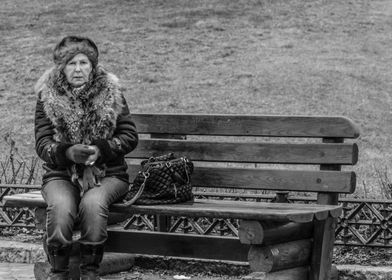 Lonely woman in the park on the bench