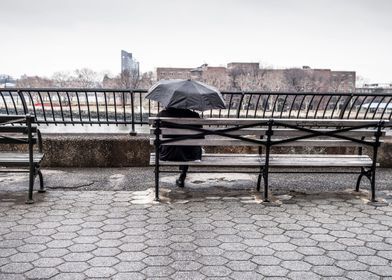 man umbrella bench city