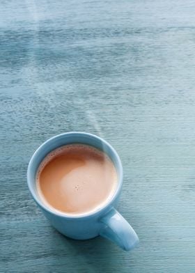 Milk coffee in a blue cup