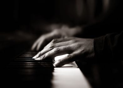 Hands playing piano close