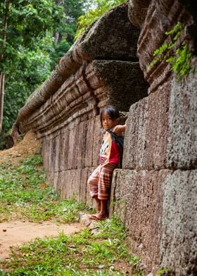 Asian kid against a wall