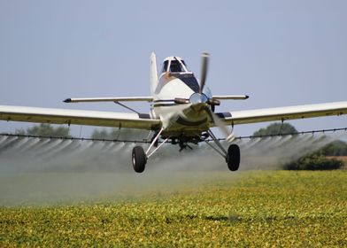 Airplane Spraying a Field