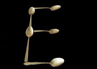 Letter E made of spoons 