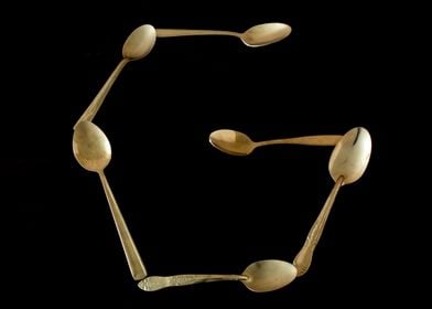 Letter G made of spoons 