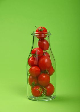 Tomatoes bottle on green