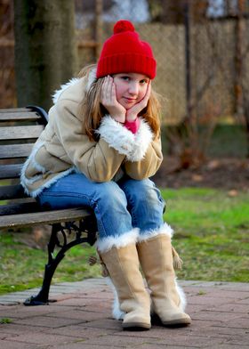 little girl on a bench