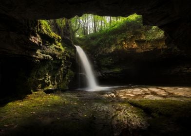 A cave with a waterfall