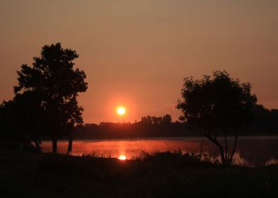 Sun Rising Over a River