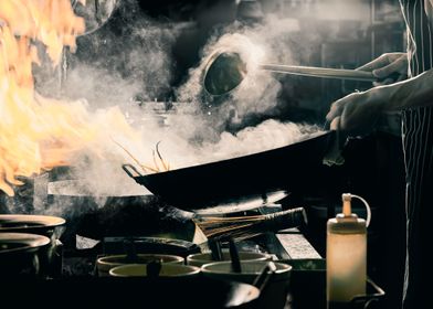 Chef stir fry in wok