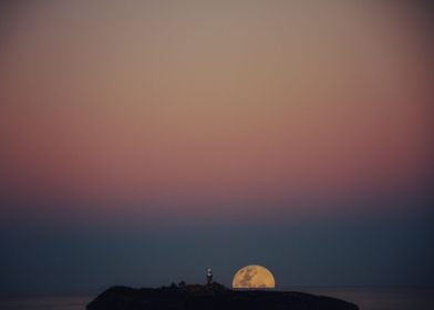 Moon against lighthouse