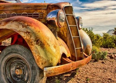 Rusting car in desert