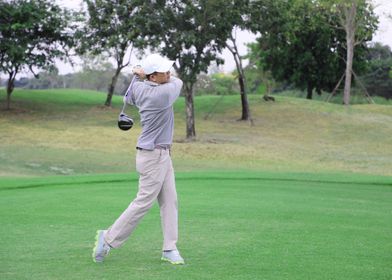 golfer teeing off golf bal