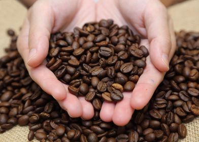 hand with coffee beans