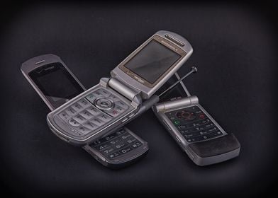 Three Flip Phones on Black