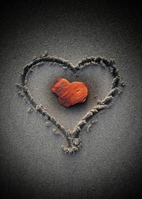 Red heart in the sand