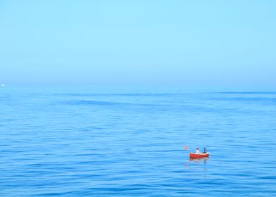 Red boat in a blue sea