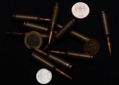 Coins and ammo on black