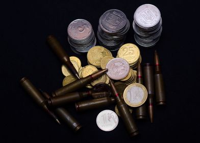 Coins and ammo on black