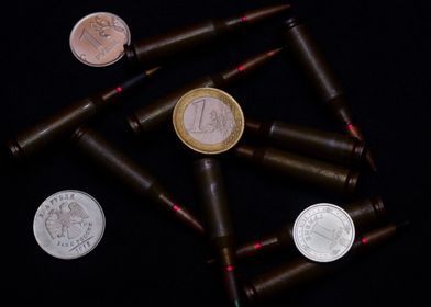 Coins and ammo on black