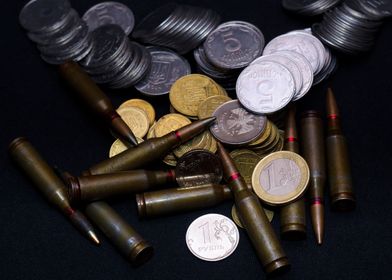 Coins and ammo on black