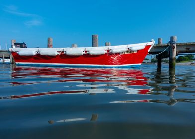 Docked rowboat reflects