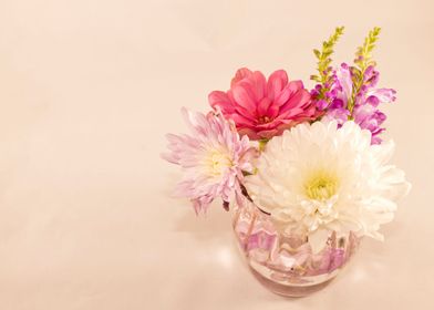 Flowers in vase on pink