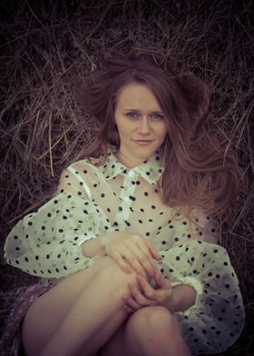 Young woman in a haystack