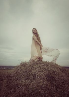 Young woman in a haystack