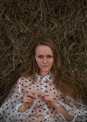 Young woman in a haystack