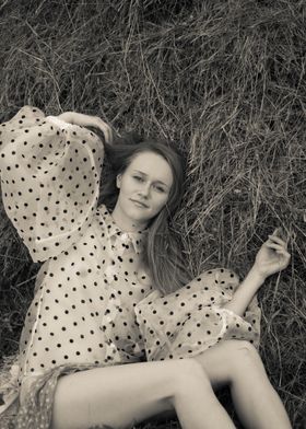 Young woman in a haystack