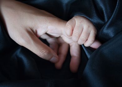 Baby hand touch mother