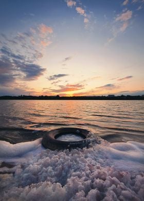 foamy tire on a pond shore