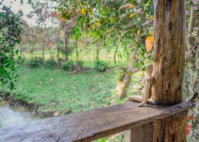 Wooden manikin sitting 