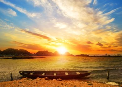 Sunset on beach with boat