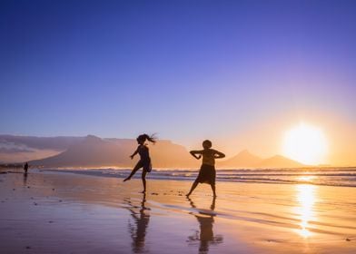 Women dancing on beach