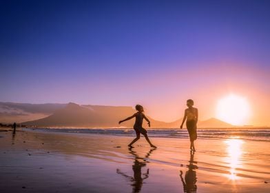 Women dancing on beach