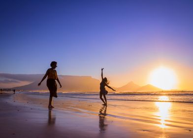 Women dancing on beach