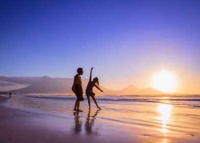 Women dancing on beach