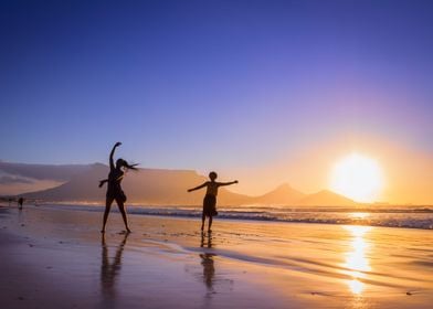 Women dancing on beach