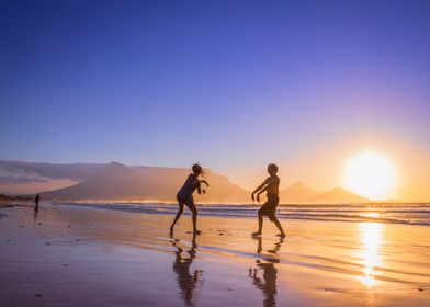 Women dancing on beach