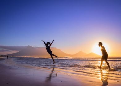 Women dancing on beach