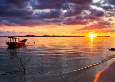 Boat on sea at sunset