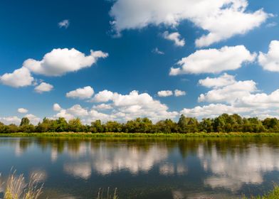 River and clouds reflected