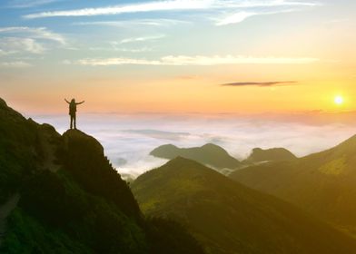 Hiker watches sunset