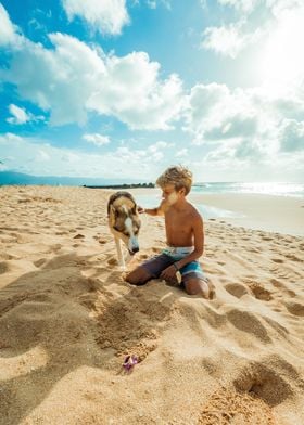 BOY WITH DOG ON THE BEACH