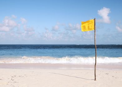 Yellow flag on the beach