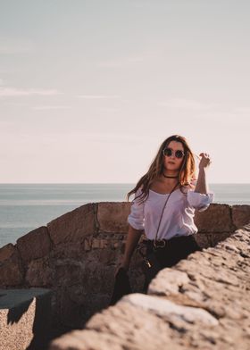 Girl walking along a wall