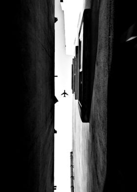 Plane between buildings
